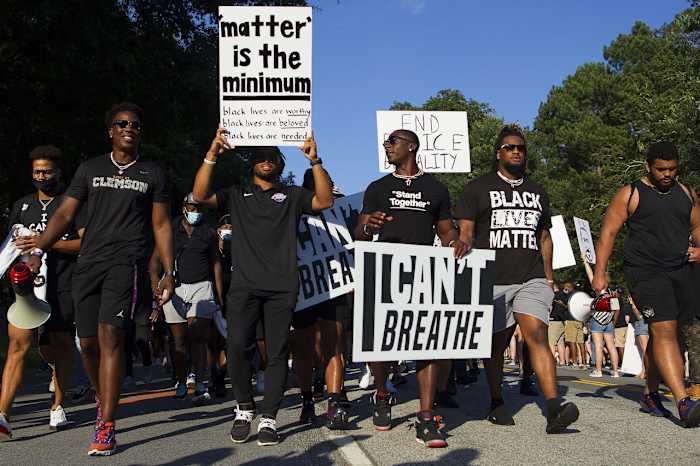 Darien Rencher (center left) and Cornell Powell (center right)